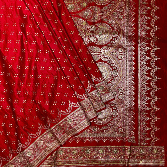 Red fabric with intricate gold patterns